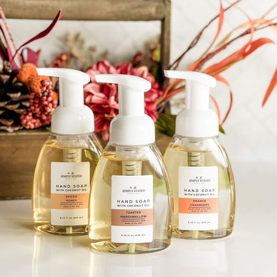 Simply Stated Fall Foaming Hand Soap in Orange Cranberry, Spiced Honey, and Toasted Marshmallow with floral fall background