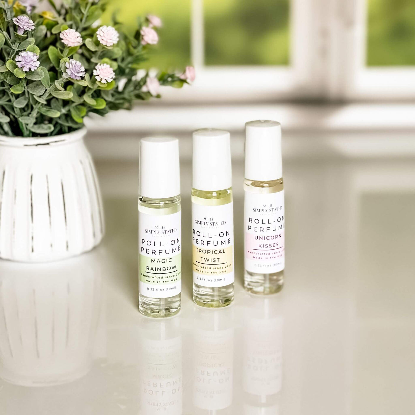 A trio of Simply Stated Bath & Body’s Kids Roll-On Perfume in Magic Rainbow, Tropical Twist, and Unicorn Kisses, designed with gentle, kid-friendly scents in a mess-free roll-on applicator.